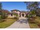 Charming two-story home with a large driveway, mature trees, and manicured landscaping at 14901 17Th E Ave, Bradenton, FL 34212