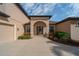 Charming home featuring a welcoming arched entryway, manicured landscaping, and a convenient two-car garage at 14901 17Th E Ave, Bradenton, FL 34212