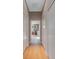 Hallway featuring wood floors and access to the main bathroom with a glass shower at 14901 17Th E Ave, Bradenton, FL 34212