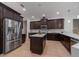 Spacious kitchen with stainless steel appliances, center island, and dark wood cabinetry at 14901 17Th E Ave, Bradenton, FL 34212