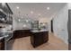 Bright and modern kitchen with an island, stainless steel appliances, and a view of the connected living area at 14901 17Th E Ave, Bradenton, FL 34212