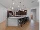 Spacious kitchen featuring an island, white marble countertops, and stylish dark-wood cabinetry at 14901 17Th E Ave, Bradenton, FL 34212