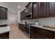 Beautiful kitchen showcasing dark wood cabinetry, stainless steel appliances, and quartz countertops at 14901 17Th E Ave, Bradenton, FL 34212