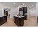 A well-lit kitchen island shows the layout and flow of the kitchen and adjoining living space at 14901 17Th E Ave, Bradenton, FL 34212