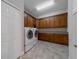Laundry room with washer, dryer, and custom built-in cabinetry at 14901 17Th E Ave, Bradenton, FL 34212