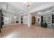 Bright living room area with hardwood floors and large decorative mirrors, connecting to other rooms at 14901 17Th E Ave, Bradenton, FL 34212