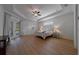 Bright main bedroom featuring hardwood floors, tray ceiling, and access to the pool at 14901 17Th E Ave, Bradenton, FL 34212