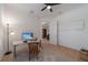 Well lit office with a desk, ceiling fan, and neutral decor in a spacious room at 14901 17Th E Ave, Bradenton, FL 34212