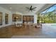 Covered outdoor living space includes comfortable seating, a ceiling fan, and views of the pool and yard at 14901 17Th E Ave, Bradenton, FL 34212