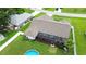 Aerial view of the home showcasing the backyard, pool, screened in lanai, and lawn at 1498 Truval Ter, Port Charlotte, FL 33952