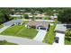 Charming single-story home features a manicured front lawn and mature landscaping at 1498 Truval Ter, Port Charlotte, FL 33952