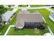 Aerial view of the home showcasing the backyard, pool, screened in lanai, and lawn at 1498 Truval Ter, Port Charlotte, FL 33952