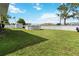 Spacious backyard with well-maintained lawn, above ground pool and white fence at 1498 Truval Ter, Port Charlotte, FL 33952