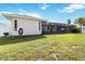 Large backyard featuring a screened-in lanai with a view of the lawn at 1498 Truval Ter, Port Charlotte, FL 33952