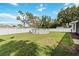 Backyard featuring a above-ground pool surrounded by green grass and a white fence at 1498 Truval Ter, Port Charlotte, FL 33952