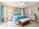 Bright bedroom with white wicker furniture, blue quilt, and serene ambiance at 1498 Truval Ter, Port Charlotte, FL 33952