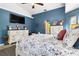 Comfortable bedroom with bright blue walls, high ceilings, and a queen bed at 1498 Truval Ter, Port Charlotte, FL 33952