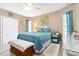 Bright bedroom with white wicker furniture, blue quilt, and serene ambiance at 1498 Truval Ter, Port Charlotte, FL 33952