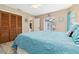 Bedroom features a large bed, wooden closet, and sliding glass doors with access to the patio at 1498 Truval Ter, Port Charlotte, FL 33952