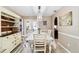Dining room features a floral tablecloth, white chairs, and built in cabinet at 1498 Truval Ter, Port Charlotte, FL 33952