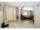 Welcoming entryway with view to the living room and light colored floors at 1498 Truval Ter, Port Charlotte, FL 33952