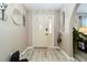 Bright entryway with light floors and an arched entry to the living room at 1498 Truval Ter, Port Charlotte, FL 33952