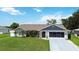 Inviting single-story home featuring a neatly maintained lawn, complementing the home's exterior at 1498 Truval Ter, Port Charlotte, FL 33952