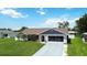 Charming single-story home with a well-manicured lawn and attached garage, great curb appeal at 1498 Truval Ter, Port Charlotte, FL 33952