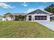 Charming single-story home featuring a lush green lawn and attached garage, great for families at 1498 Truval Ter, Port Charlotte, FL 33952