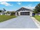 Beautiful single-story home with an attached garage and a well-kept driveway and lawn at 1498 Truval Ter, Port Charlotte, FL 33952