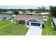 Well-kept single-story home showcasing a green lawn, and attached garage, a great neighborhood at 1498 Truval Ter, Port Charlotte, FL 33952