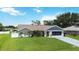 Lovely single-story home displaying a lush green lawn, and attached garage, enhancing its appeal at 1498 Truval Ter, Port Charlotte, FL 33952