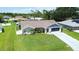 Well-maintained single-story home displaying a beautiful lawn and attached garage, great curb appeal at 1498 Truval Ter, Port Charlotte, FL 33952