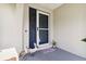 Inviting front porch with blue door and screen door at 1498 Truval Ter, Port Charlotte, FL 33952