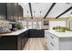 Modern kitchen with granite countertops, stainless steel appliances, and dark-stained cabinetry at 1498 Truval Ter, Port Charlotte, FL 33952