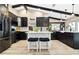 Updated kitchen features an island with seating, black cabinets, and stainless steel appliances at 1498 Truval Ter, Port Charlotte, FL 33952