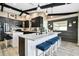 Modern kitchen features large island with seating, black cabinets, and wood accent wall at 1498 Truval Ter, Port Charlotte, FL 33952