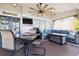 Covered outdoor lanai featuring a ceiling fan and comfortable seating area at 1498 Truval Ter, Port Charlotte, FL 33952