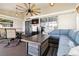 Inviting lanai with comfortable blue seating, ceiling fan, and relaxing decor at 1498 Truval Ter, Port Charlotte, FL 33952