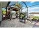 Lanai features outdoor kitchen area with grill, seating and lush landscaping at 1498 Truval Ter, Port Charlotte, FL 33952