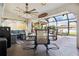 Relaxing screened-in lanai with outdoor seating and dining area, and a view of the pool at 1498 Truval Ter, Port Charlotte, FL 33952
