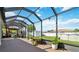 Spacious screened-in lanai with a view of the well-maintained backyard and pool at 1498 Truval Ter, Port Charlotte, FL 33952