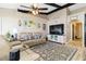 Cozy living room features vaulted ceilings with wood beams and a neutral color palette at 1498 Truval Ter, Port Charlotte, FL 33952