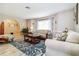 Bright living room with a beautiful blue rug, neutral furniture, and natural light at 1498 Truval Ter, Port Charlotte, FL 33952