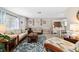Bright living room with an area rug, wood furniture, and views into the dining area at 1498 Truval Ter, Port Charlotte, FL 33952