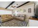 Inviting living room with neutral furniture, wood beams, and bright natural lighting at 1498 Truval Ter, Port Charlotte, FL 33952