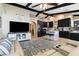 Spacious open-concept living room flows into the gourmet kitchen featuring dark cabinetry and an island at 1498 Truval Ter, Port Charlotte, FL 33952