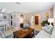 Comfortable living room features a wood coffee table and archways that lead to other rooms at 1498 Truval Ter, Port Charlotte, FL 33952