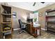 Well-organized office space with wood flooring, shelving, desk, comfortable chair, and a printer at 1498 Truval Ter, Port Charlotte, FL 33952