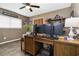 Functional home office space with wood desk, modern monitors, and natural light from the window at 1498 Truval Ter, Port Charlotte, FL 33952